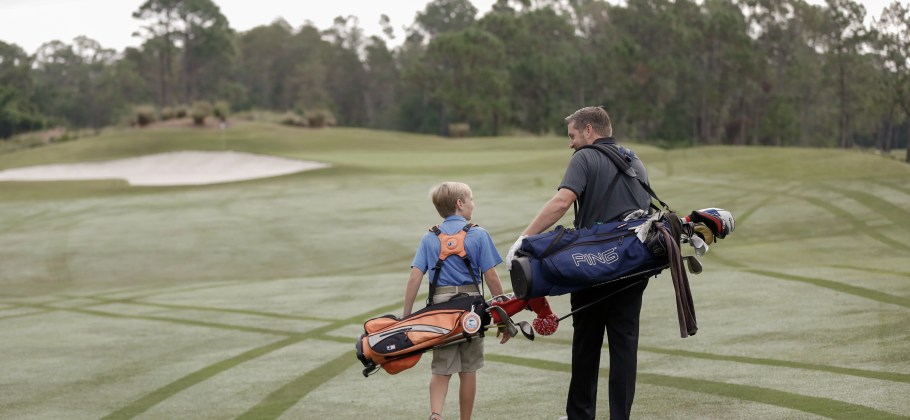 Father and son walk a 9 hole golf round